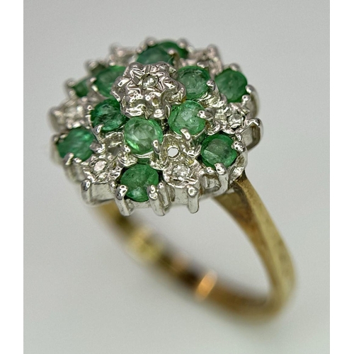 299 - A 9K YELLOW GOLD DIAMOND AND EMERALD CLUSTER RING. 2.7G. SIZE J.