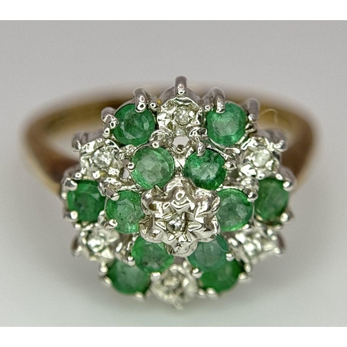 299 - A 9K YELLOW GOLD DIAMOND AND EMERALD CLUSTER RING. 2.7G. SIZE J.