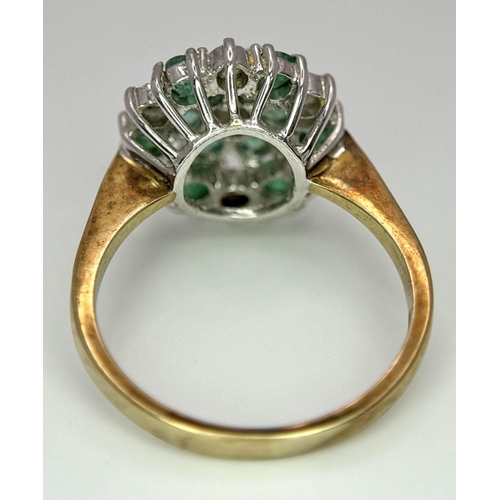 299 - A 9K YELLOW GOLD DIAMOND AND EMERALD CLUSTER RING. 2.7G. SIZE J.