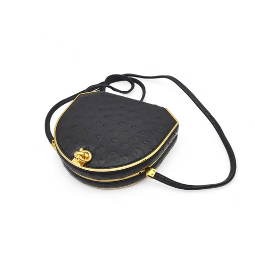 44 - An Asprey of London Black Ostrich Shoulder Bag. Comes with original Asprey box and mirror. Gilded ha... 