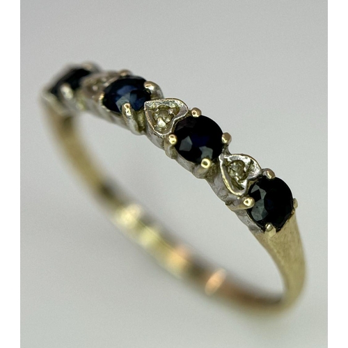 811 - A 9K GOLD RING WITH HEART SHAPED DIAMONDS AND SAPPHIRES.   1.2    size M