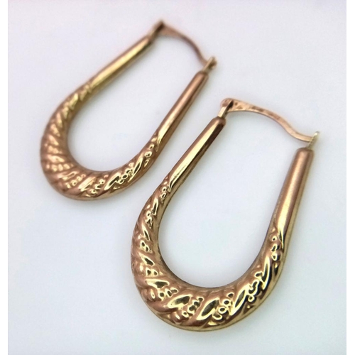 818 - A 9K GOLD PAIR OF HORSE SHOE SHAPED EARRINGS . 1.1gms