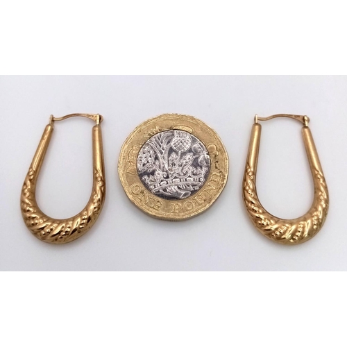 818 - A 9K GOLD PAIR OF HORSE SHOE SHAPED EARRINGS . 1.1gms