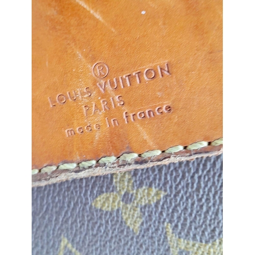 17 - A Louis Vuitton Vintage Large Suitcase. Monogrammed canvas exterior with leather trim, gold-toned ha... 