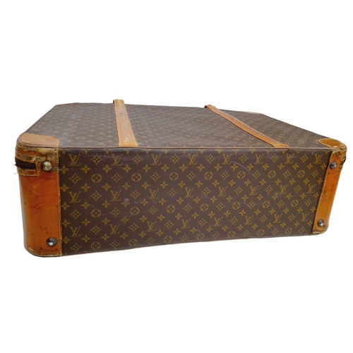 17 - A Louis Vuitton Vintage Large Suitcase. Monogrammed canvas exterior with leather trim, gold-toned ha... 