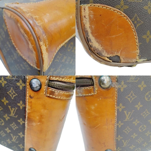 17 - A Louis Vuitton Vintage Large Suitcase. Monogrammed canvas exterior with leather trim, gold-toned ha... 