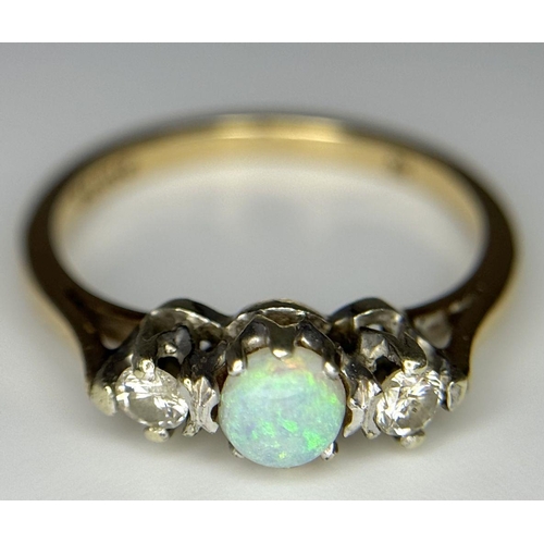 220 - A 9k Yellow Gold Opal and Diamond Ring. Central colour play opal with a brilliant round cut diamond ... 