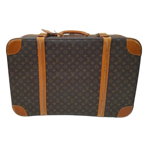 23 - A Louis Vuitton Vintage Medium Suitcase. Monogrammed canvas exterior with leather trim, gold-toned h... 