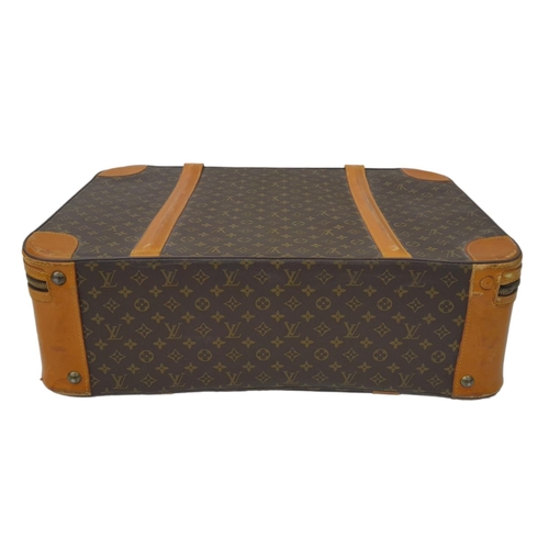 23 - A Louis Vuitton Vintage Medium Suitcase. Monogrammed canvas exterior with leather trim, gold-toned h... 