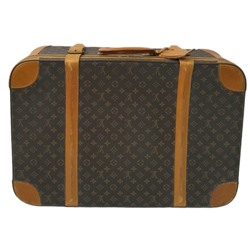 23 - A Louis Vuitton Vintage Medium Suitcase. Monogrammed canvas exterior with leather trim, gold-toned h... 