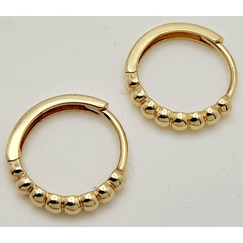 295 - A Pair of 14k Gold Designer Messika Hoop Earrings. 1.1g