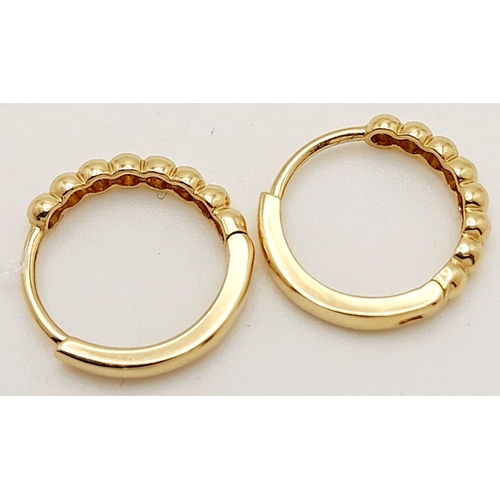 295 - A Pair of 14k Gold Designer Messika Hoop Earrings. 1.1g