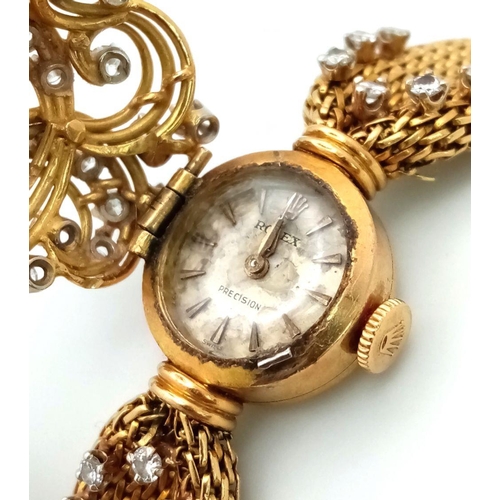 51 - A VINTAGE 18K GOLD AND DIAMOND LADIES ROLEX DRESS WATCH . A WOVEN 18K GOLD STRAP COMPLIMENTED BY A H... 