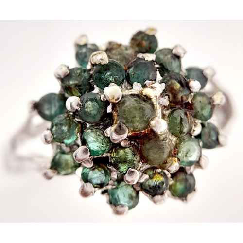 513 - A Sterling Silver Emerald Cluster Ring. Ring size W 1/2. Total weight: 5.92g.

ref: HV 2304