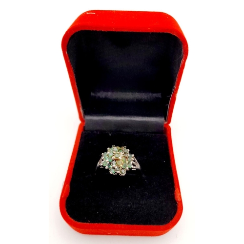 513 - A Sterling Silver Emerald Cluster Ring. Ring size W 1/2. Total weight: 5.92g.

ref: HV 2304