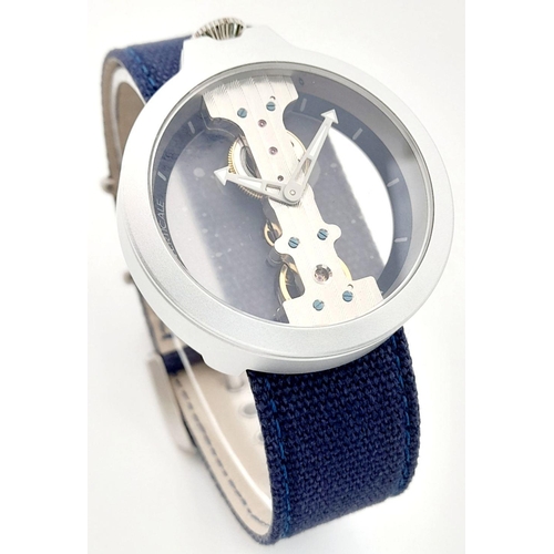 618 - A Verticale Mechanical Top Winder Gents Watch. Blue denim strap. Ceramic silver tone skeleton case -... 