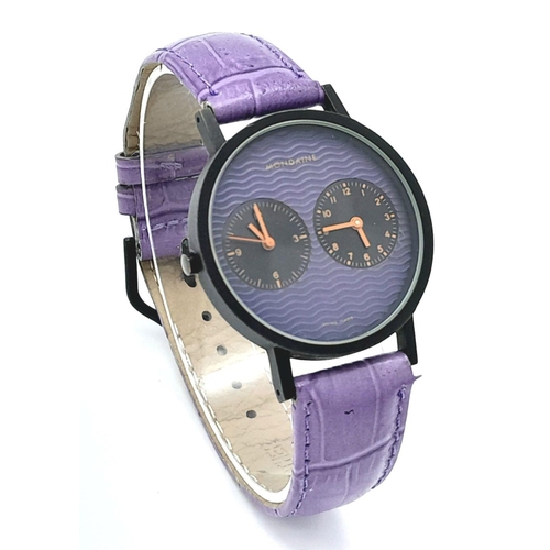 628 - A Mondaine Dual Time Quartz Ladies Watch. Purple leather strap. Case - 36mm. Purple dial with two su... 