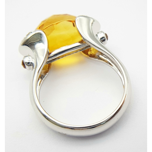 8 - An 18K White Gold Citrine and Diamonds Ring. Size N1/2, 7.58g total weight.