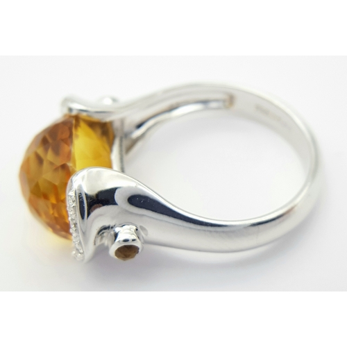 8 - An 18K White Gold Citrine and Diamonds Ring. Size N1/2, 7.58g total weight.