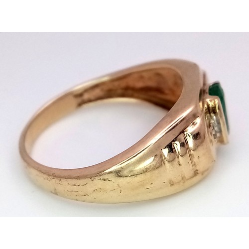 16 - A 9K Yellow Gold Emerald and Diamond Ring. Oval cut emerald with a diamond either side. Size T 1/2. ... 