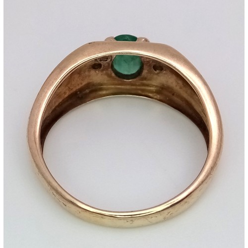 16 - A 9K Yellow Gold Emerald and Diamond Ring. Oval cut emerald with a diamond either side. Size T 1/2. ... 