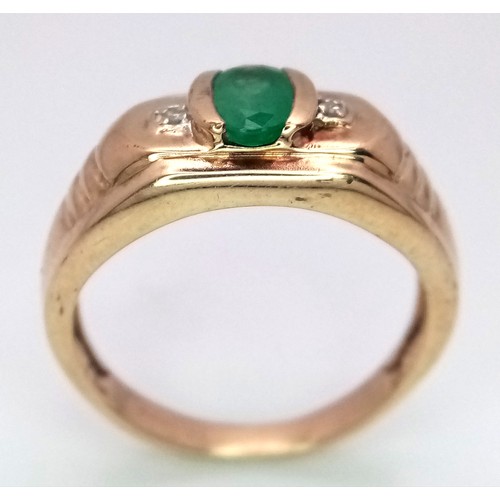 16 - A 9K Yellow Gold Emerald and Diamond Ring. Oval cut emerald with a diamond either side. Size T 1/2. ... 