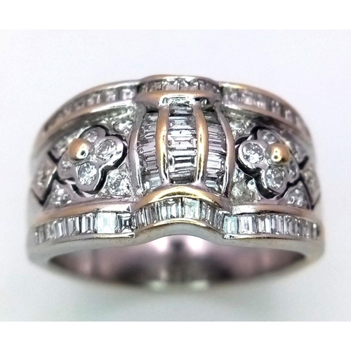 129 - An 18K White Gold Decorative Diamond Ring. Seventy Round and rectangular cut diamonds create an arti... 