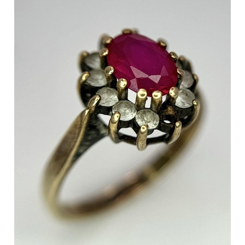 169 - A Vintage 9K Yellow Gold Ruby and Diamond Ring. Two small diamonds missing from halo. Size J. 2.5g t... 