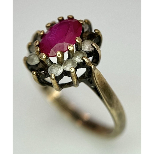 169 - A Vintage 9K Yellow Gold Ruby and Diamond Ring. Two small diamonds missing from halo. Size J. 2.5g t... 