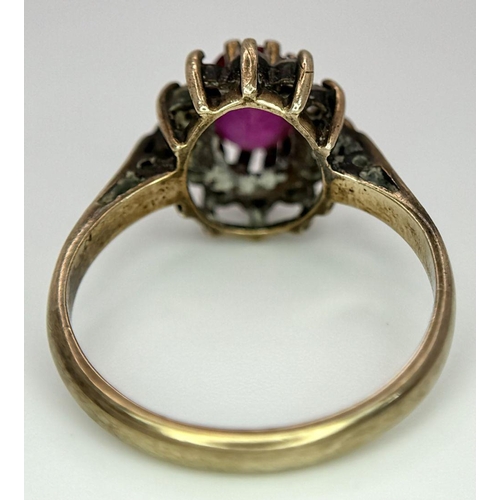 169 - A Vintage 9K Yellow Gold Ruby and Diamond Ring. Two small diamonds missing from halo. Size J. 2.5g t... 