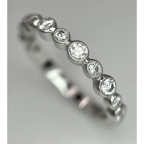 514 - A 9k White Gold Diamond Half Eternity Ring. Size M. 2.2g total weight.