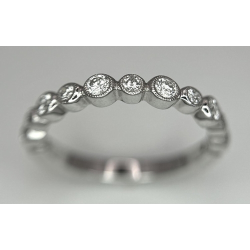 514 - A 9k White Gold Diamond Half Eternity Ring. Size M. 2.2g total weight.