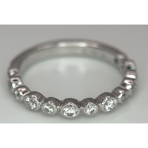 514 - A 9k White Gold Diamond Half Eternity Ring. Size M. 2.2g total weight.