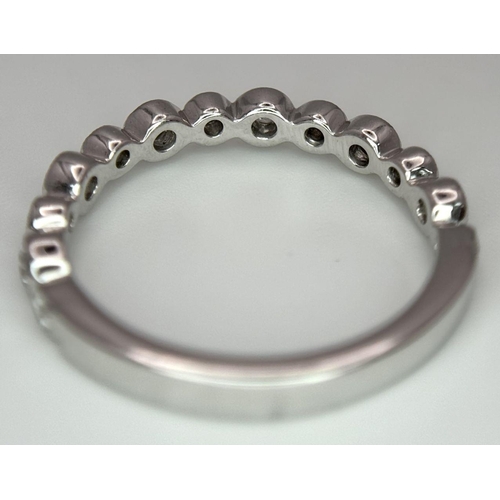 514 - A 9k White Gold Diamond Half Eternity Ring. Size M. 2.2g total weight.