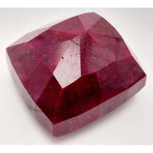 125 - A massive (676.8 carats) natural ruby, cushion cut, with evident secondary mineralisation as indicat... 