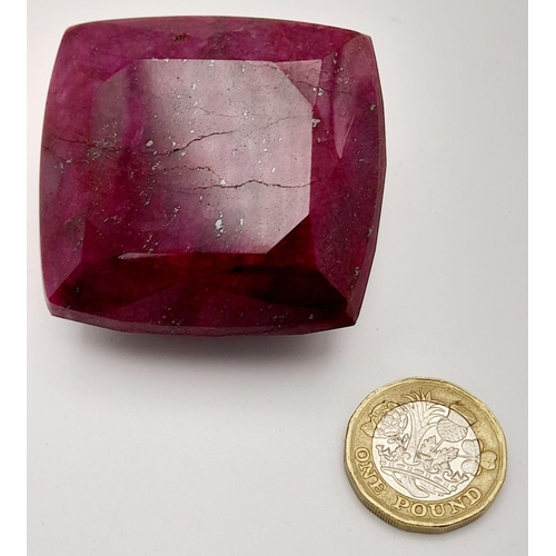 125 - A massive (676.8 carats) natural ruby, cushion cut, with evident secondary mineralisation as indicat... 