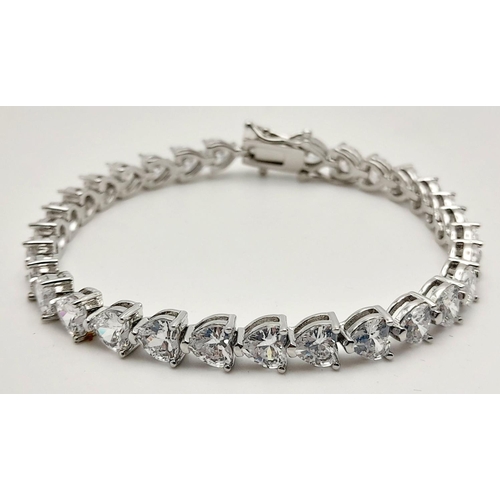 1396 - A Fancy Silver Plated White Zircon Tennis Bracelet. 17cm.