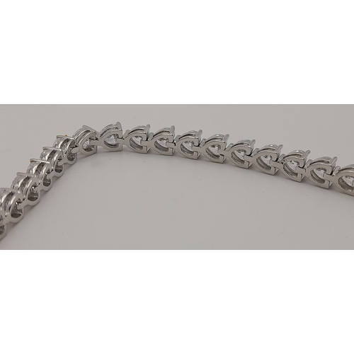 1396 - A Fancy Silver Plated White Zircon Tennis Bracelet. 17cm.