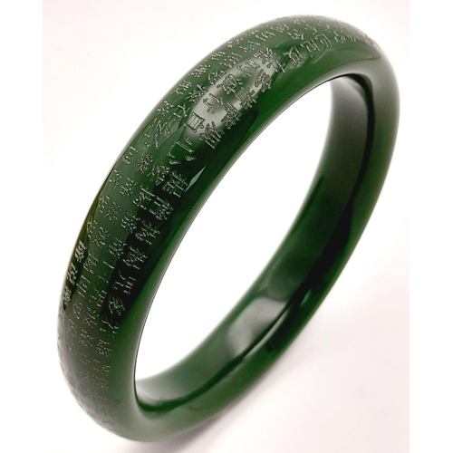 160 - Of Buddhist interest: A green jade set consisting of a bangle, a thumb ring and a pendant/amulet wit... 