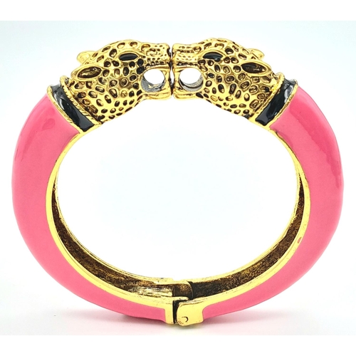 167 - A vintage, designer style, double panther bangle, gold tone with pink enamel, in excellent new/unuse... 