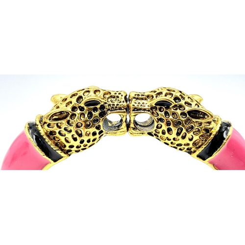 167 - A vintage, designer style, double panther bangle, gold tone with pink enamel, in excellent new/unuse... 