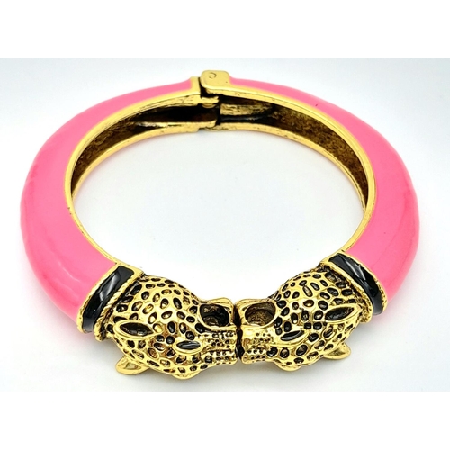 167 - A vintage, designer style, double panther bangle, gold tone with pink enamel, in excellent new/unuse... 