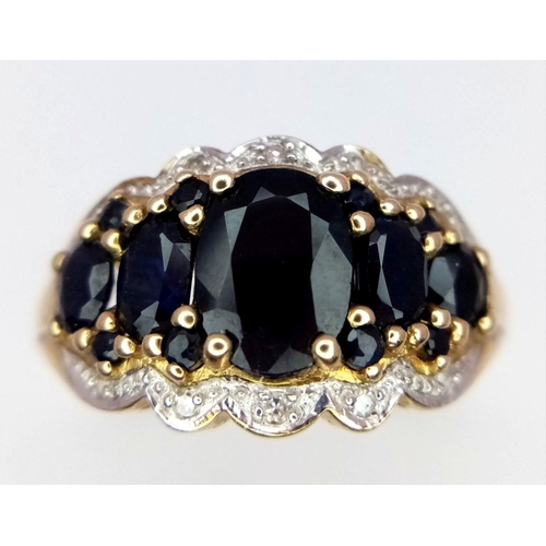 163 - A 9K Yellow Gold Sapphire and Diamond Ring. Graduated sapphires with diamond accents. Size S. 4.1g t... 