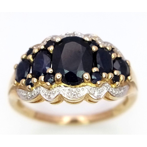 163 - A 9K Yellow Gold Sapphire and Diamond Ring. Graduated sapphires with diamond accents. Size S. 4.1g t... 