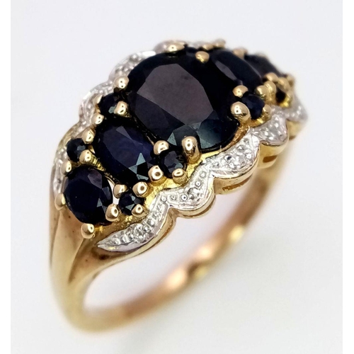 163 - A 9K Yellow Gold Sapphire and Diamond Ring. Graduated sapphires with diamond accents. Size S. 4.1g t... 