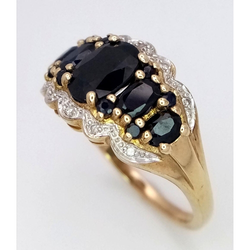 163 - A 9K Yellow Gold Sapphire and Diamond Ring. Graduated sapphires with diamond accents. Size S. 4.1g t... 