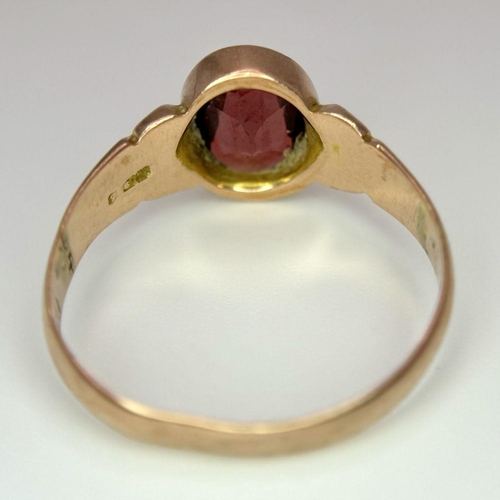 205 - A Vintage 9K Yellow Gold Garnet Ring. Full UK hallmarks. Size T 1/2. 3.4g total weight.