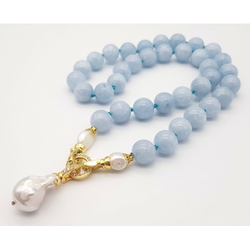 290 - An Aquamarine Beaded Necklace with a Baroque Pearl Pendant Drop. 12mm beads. 48cm necklace length. 5... 