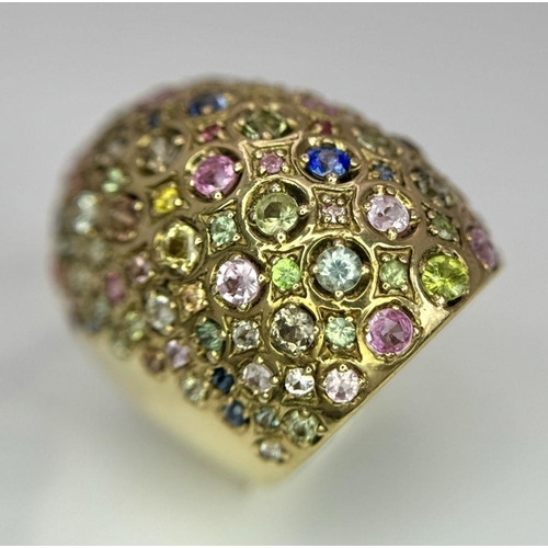 311 - A 9K Yellow Gold Multi-Coloured Sapphire Elongated Dress Ring. Size N 1/2. 13.5g total weight. Comes... 