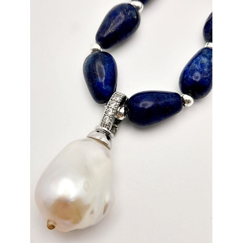 335 - A Lapis Lazuli Teardrop Necklace with Hanging Baroque Pearl Pendant. 46cm necklace length. 4cm penda... 